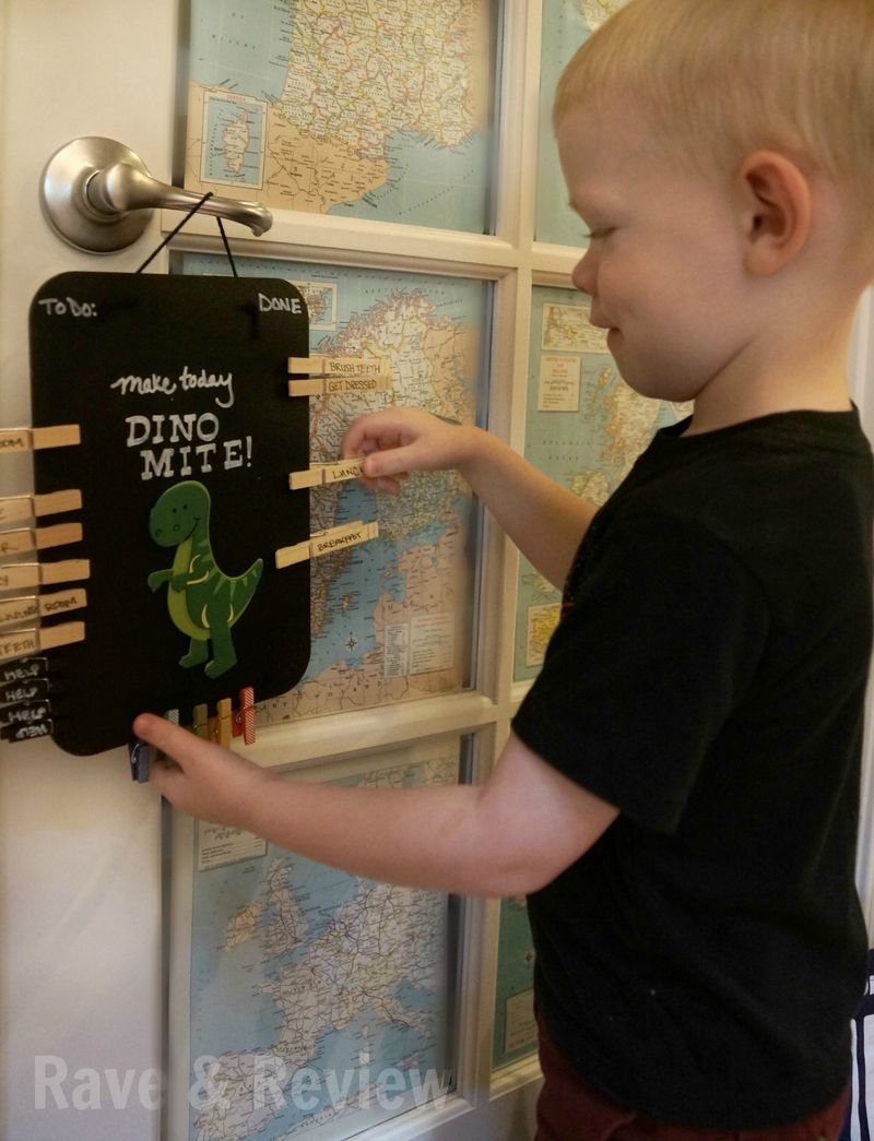 Kids moving pins on chore board