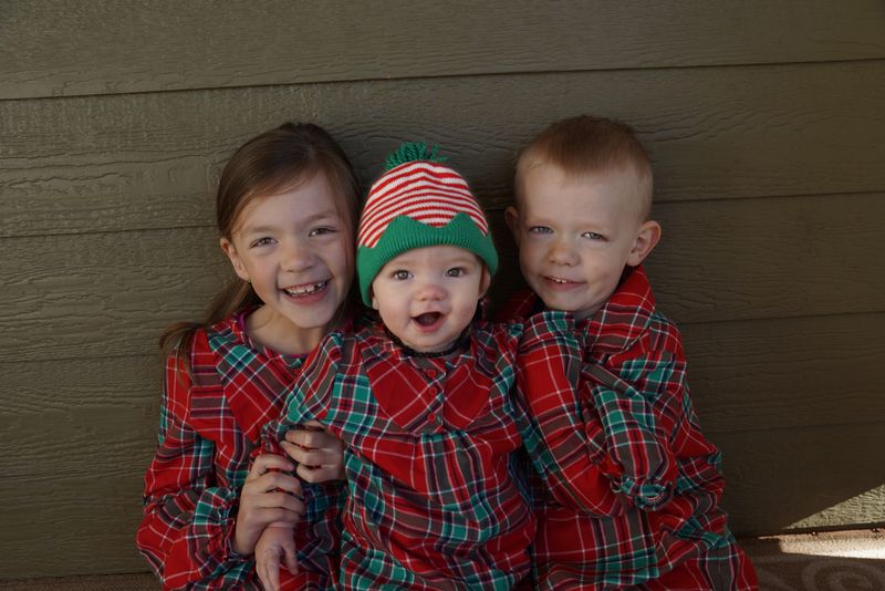 Kiddos in Christmas jammies matching outfits for baby, toddler, siblings, and family